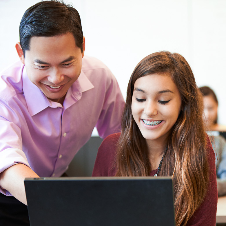 photo of a teacher working with a student